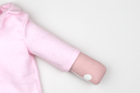 doll size sleeve roll inside the arm of a doll shirt