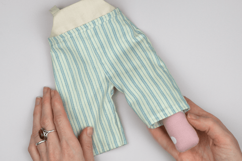 seam roll being used to press the leg of doll trousers