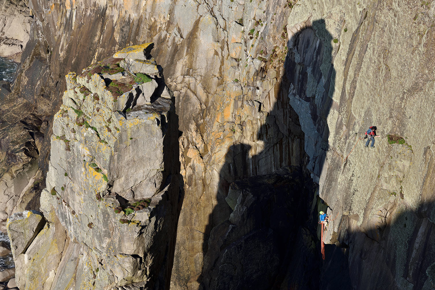 McHaffie and Bede West escaping from the shadow of the Devil's Chimney on Lundy's Promised Land (E3 6a). © Ray Wood