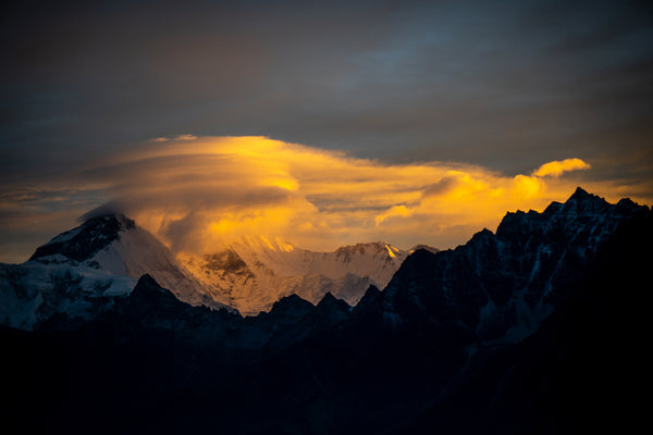 The earliest dawn light illuminates lenticular clouds over Cho Oyu, the sixth highest mountain in the world located in the Mahalanger Himalaya.