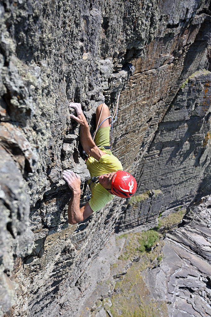 Mick Lovatt questing across the unsound steepness of Stigmata Buttress on pitch 12.