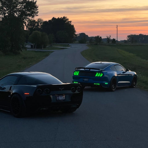 two mustangs with custom lights