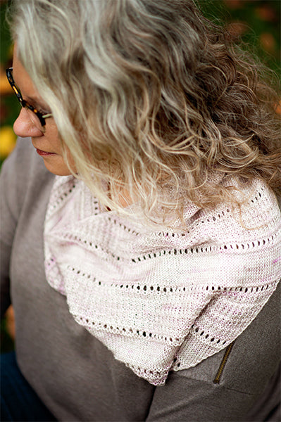 Side profile of Red Door Fibers owner Donna Simpson wearing handknit Cobblestone shawl