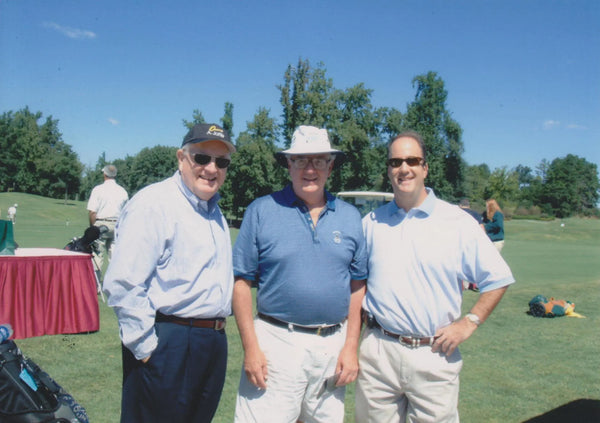 Three brothers playing golf