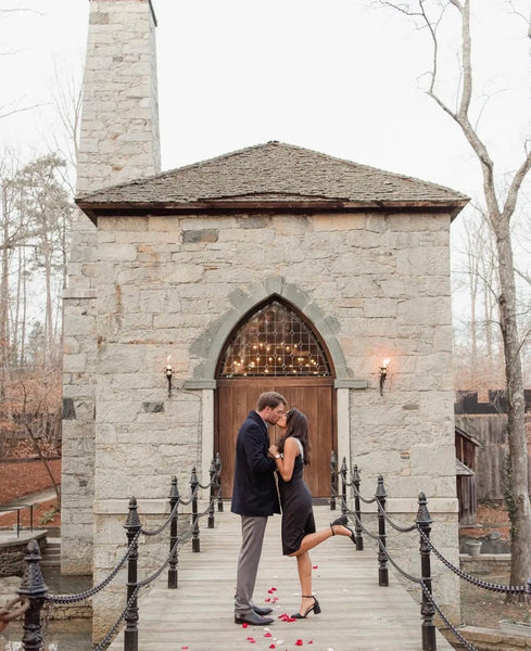 Couple kissing in front of a church