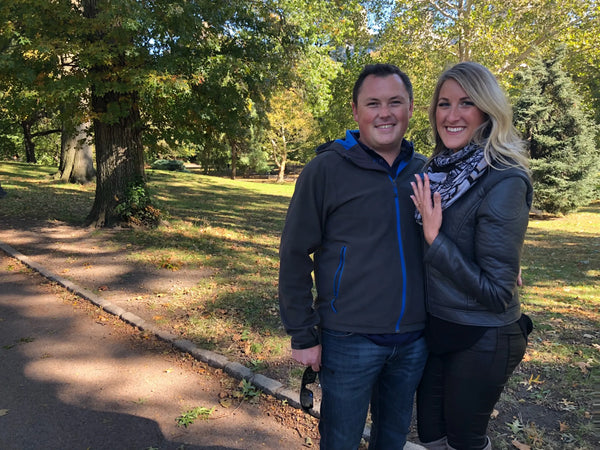 Couple in park getting engaged