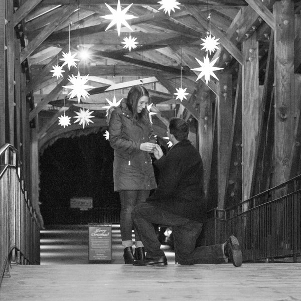 Proposal with couple on bridge with star lights