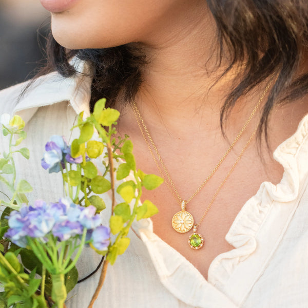 Green gemstone necklace and yellow gold necklace