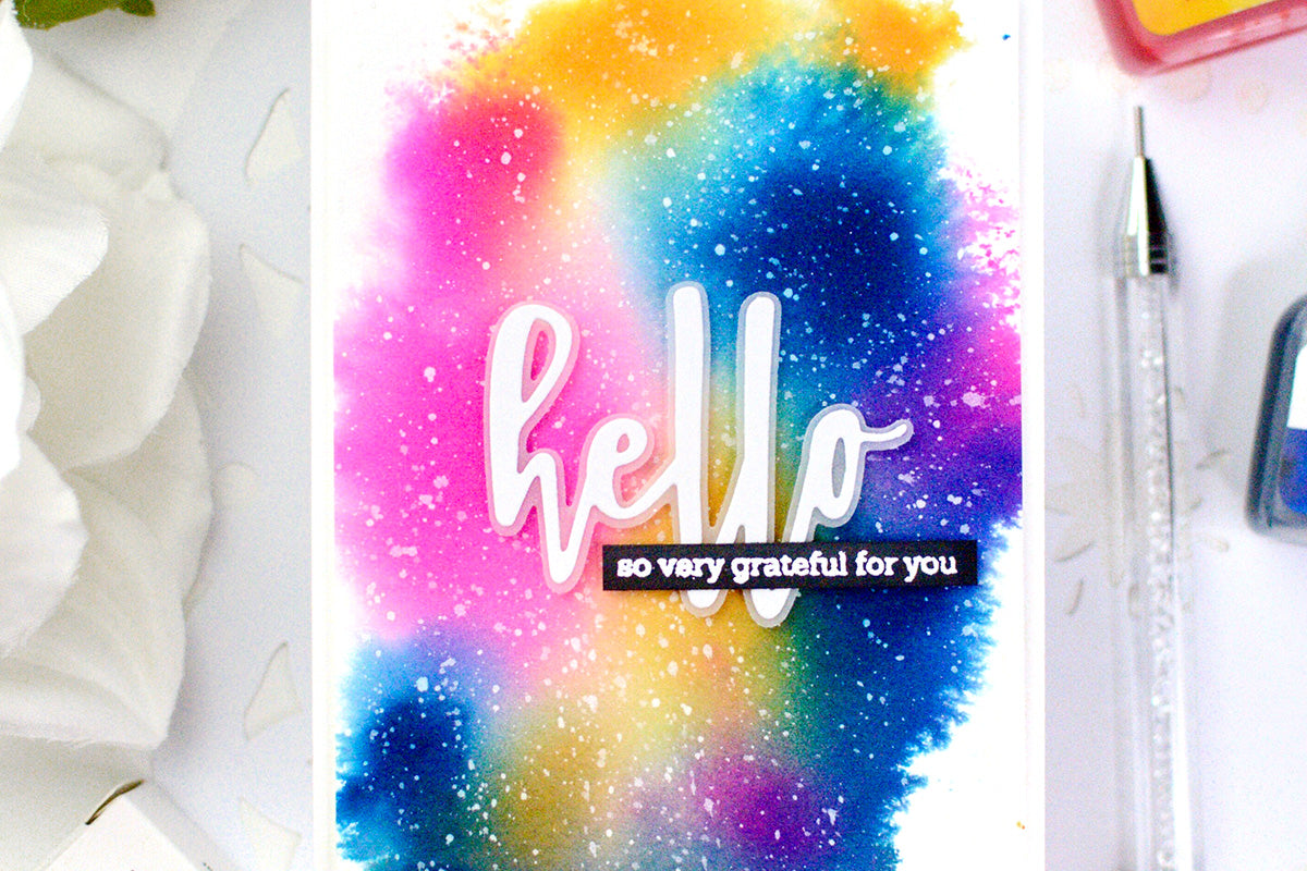 Rainbow galaxy design on a handmade greeting card, made with Artistry by Altenew Alcohol Inks