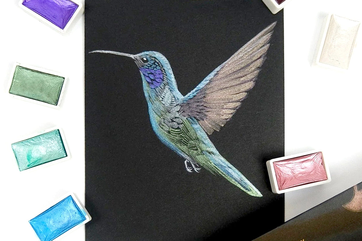 A drawing of a hummingbird created with metallic watercolors from Artistry by Altenew