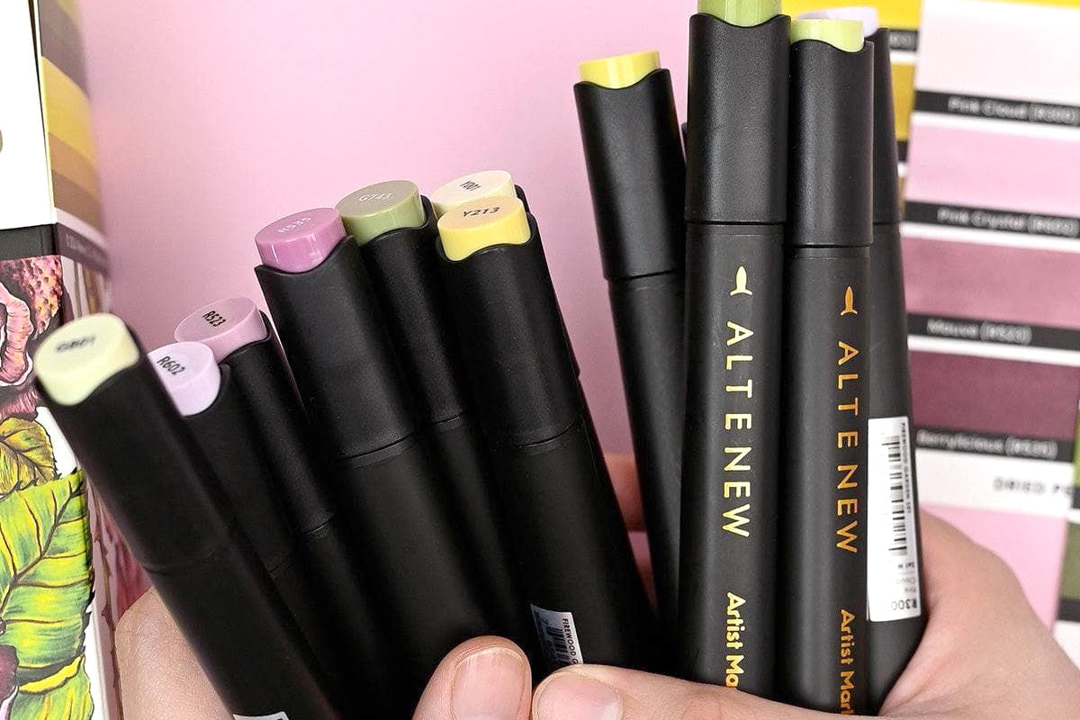 A bunch of Altenew's Artists Markers held with two hands