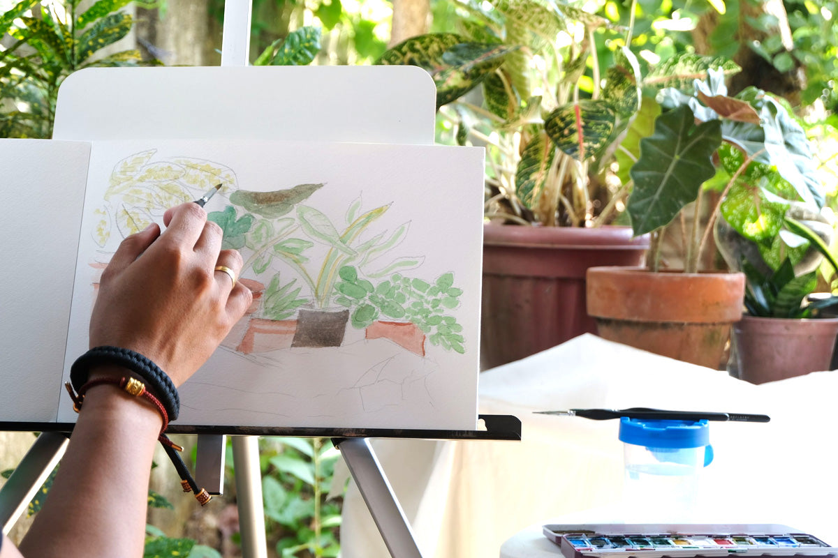 An artist finding inspiration in nature for his plein watercolor art painting