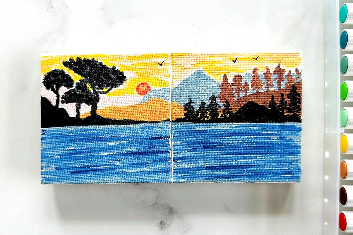 An artistic rendering of a mountain scenery over a lake, created and colored in with the 24-Color Acrylic Marker Set