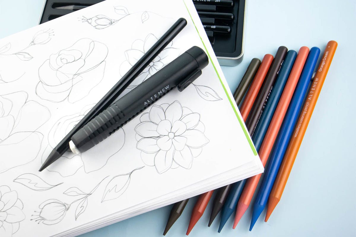 A sketchbook page with drawings and sketches of flowers and foliage, made with Artistry by Altenew's pencils