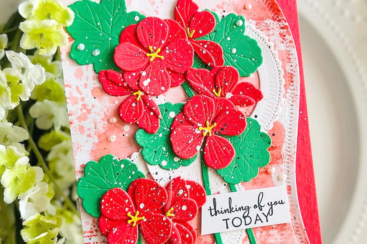 A gorgeous and vibrant card by Kailash featuring red floral die cuts