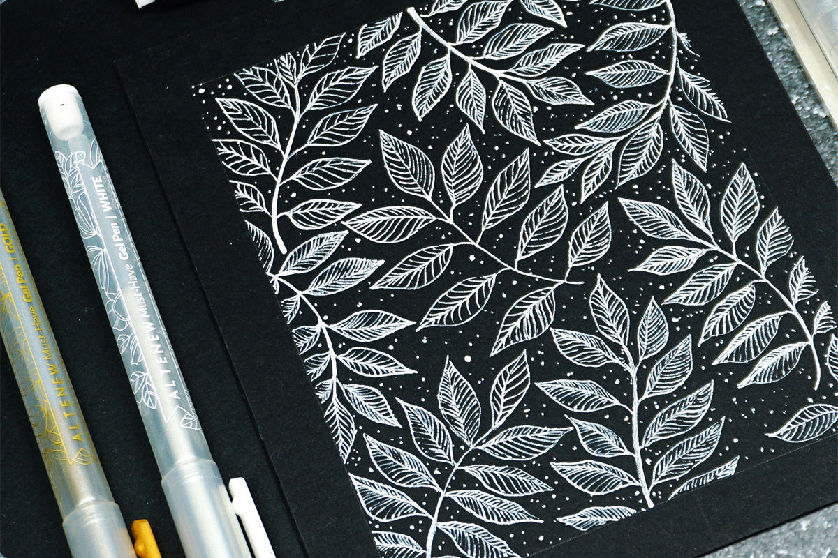 White leaves on a black cardstock, made with Artistry Must-have Gel Pen Set