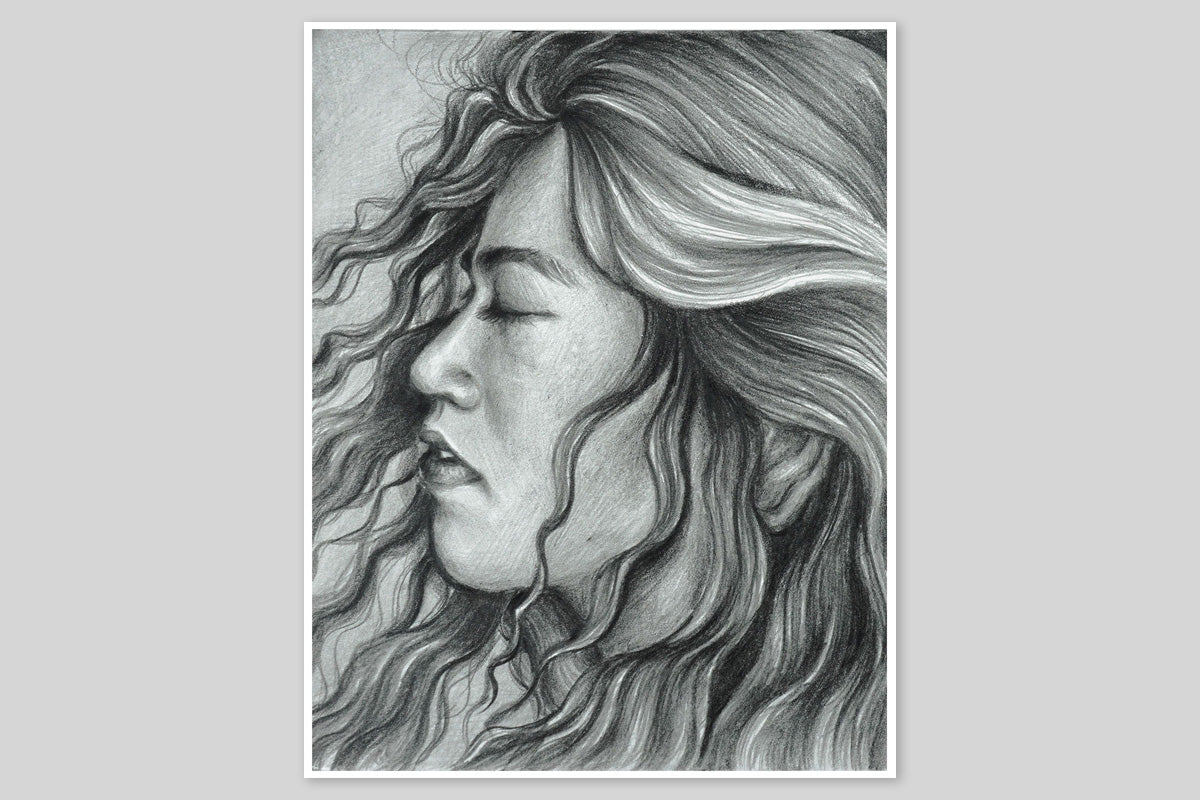 A black and white drawing featuring the side profile of a woman with her eyes closed, made with Artistry Monochrome Shading Pencils