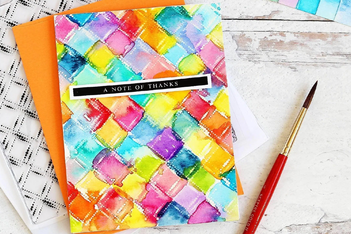 A checkered thank you card painted with bright colors