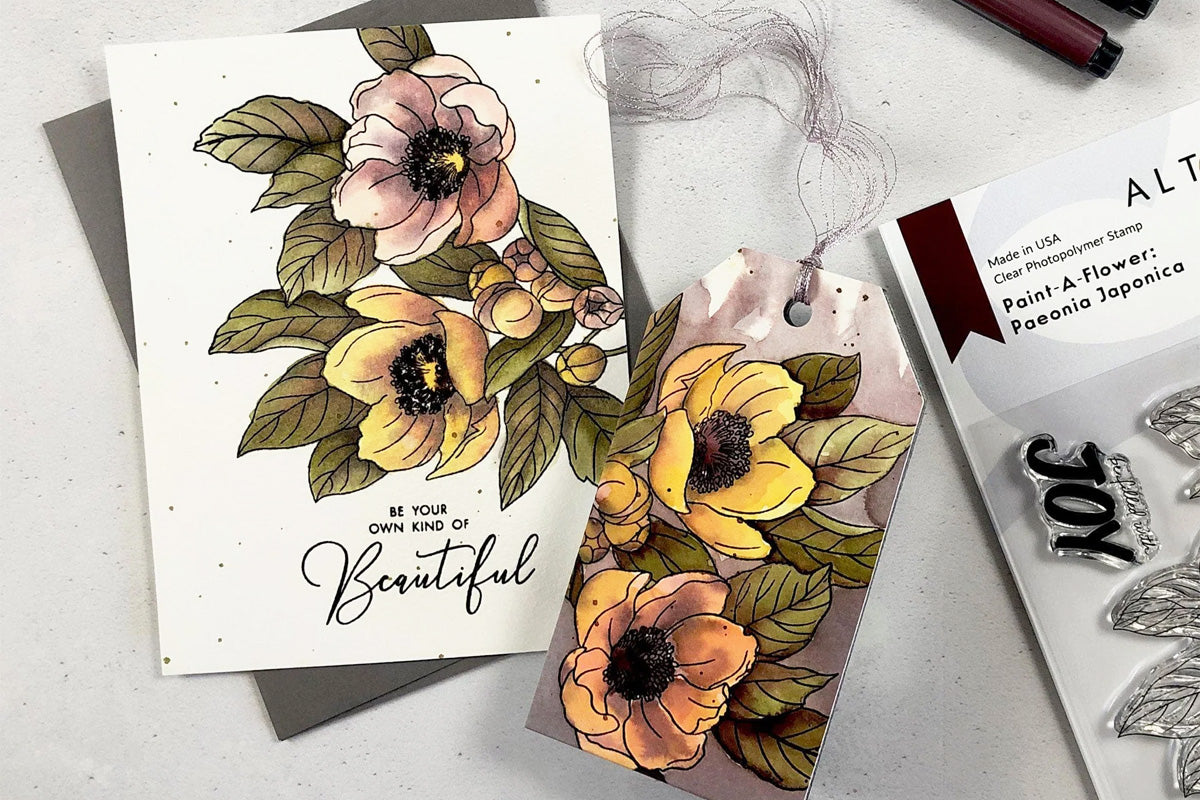 A pair of floral greeting cards and tags colored in with Artistry by Altenew's Watercolor Brush Markers