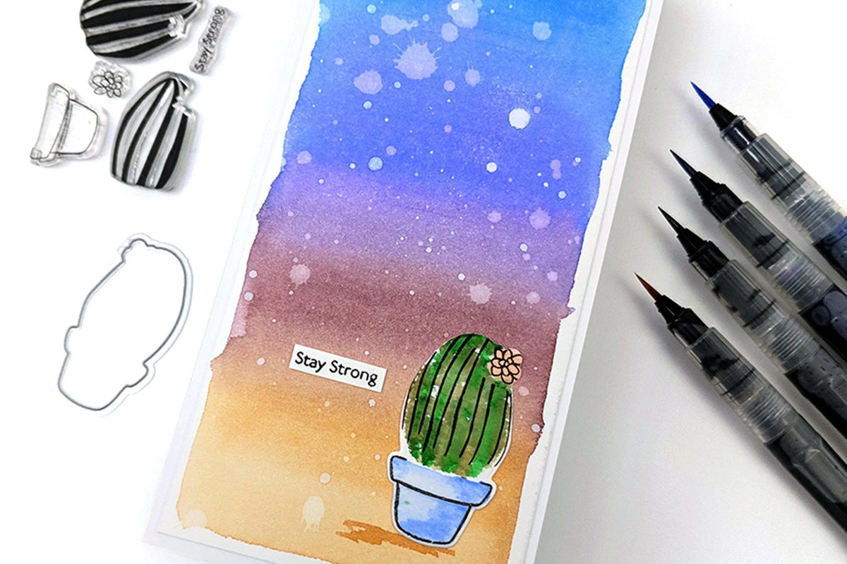 A "stay strong" slimline card with a beautiful background and a small succulent as a focal point, colored in by watercolor brush markers