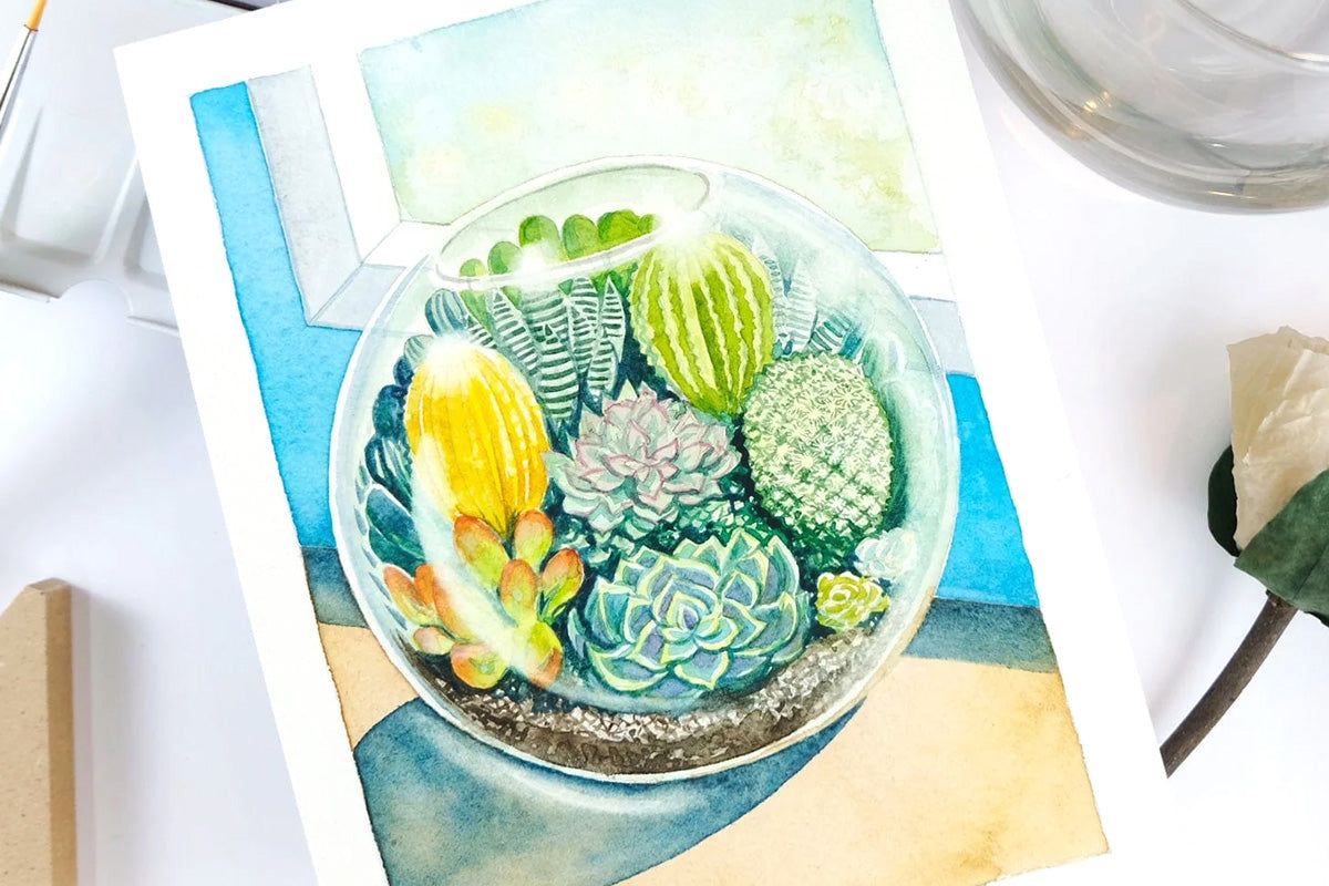 A small circular bowl with succulents, colored in with watercolor pans
