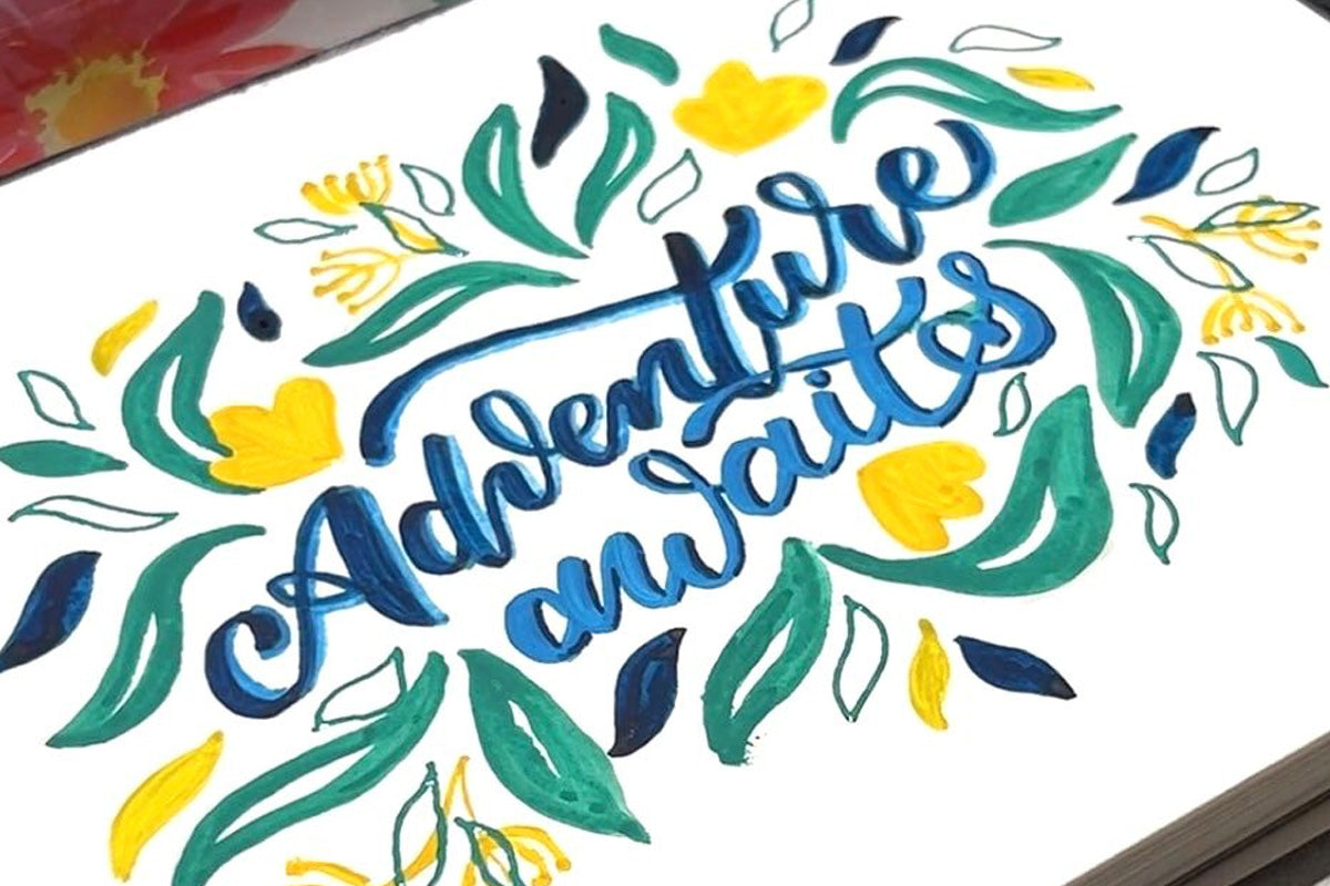 Hand lettered motivational mantra: Adventure Awaits