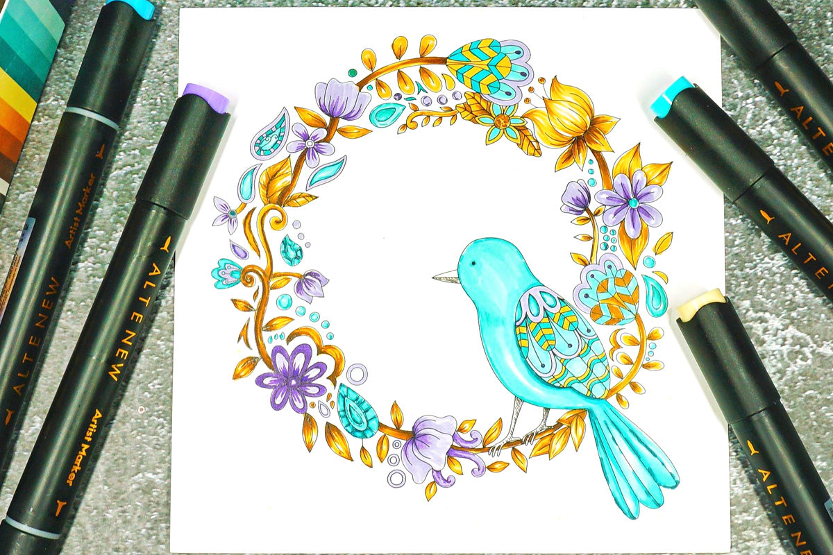 A page out of Artistry Whimsical Flower Bunch Coloring Book featuring whimsical flower wreath and a bird, colored with Water Garden Artist Alcohol Markers Set G