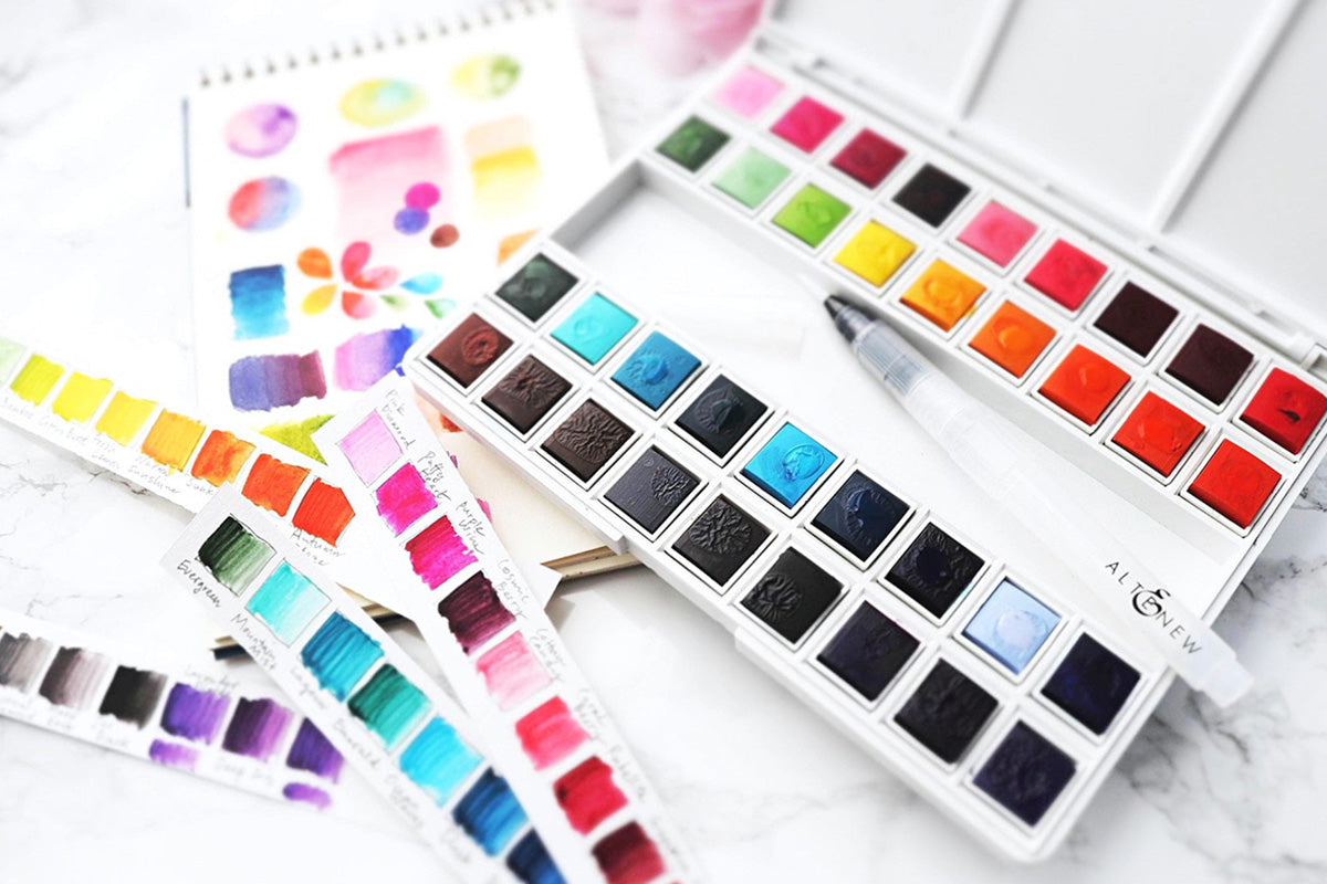 Artistry by Altenew's beginner-friendly pan watercolor set along with some watercolor swatches