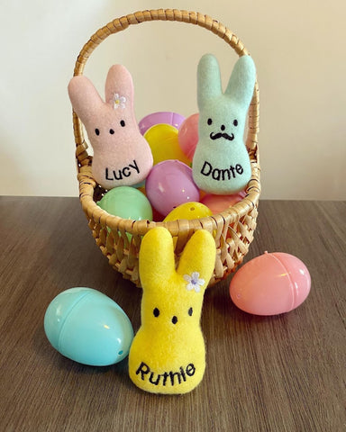 Personalized catnip peep cat toys inside of an easter basket with easter eggs
