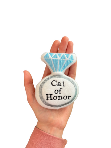 An engagement ring cat toy, personalized with a name to announce engagement or wedding.