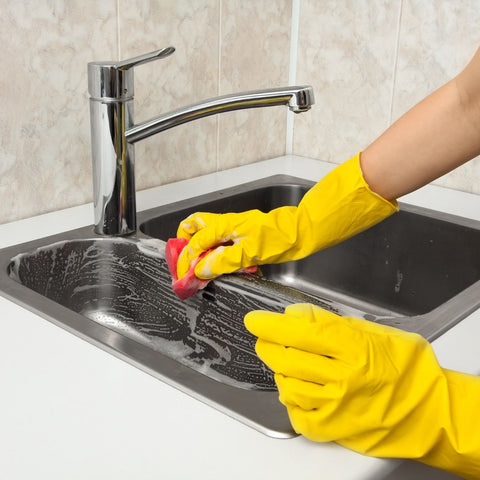 A basin being washed with a glove and soft detergent