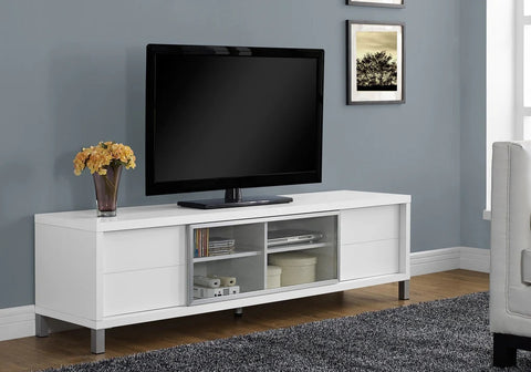 a white media cabinet with a tv perched on top
