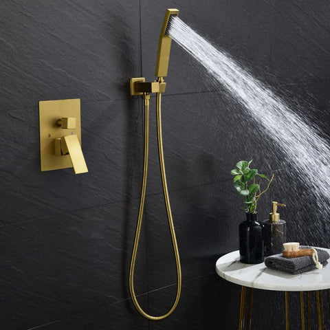A gold hand shower in a bathroom