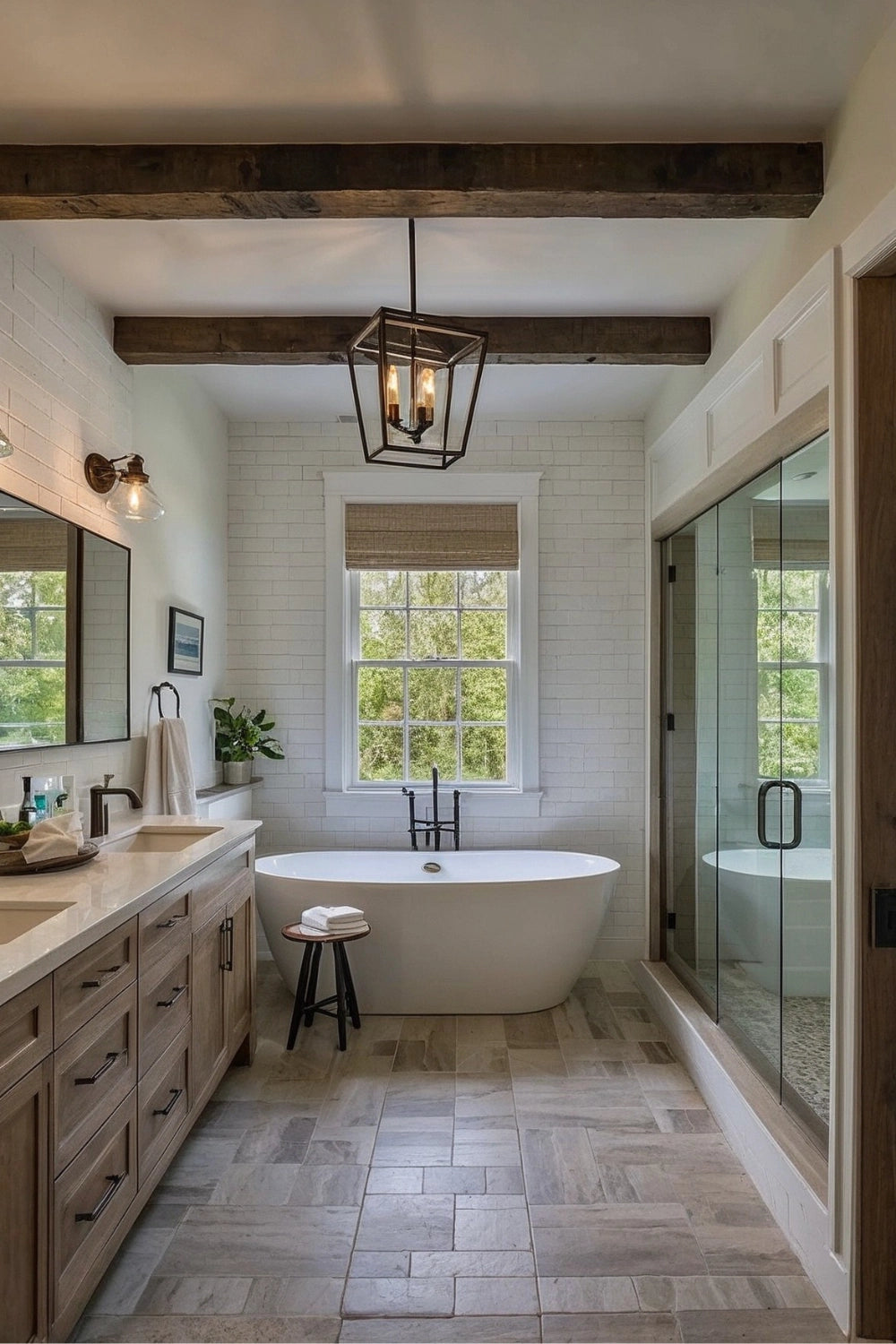 A rustic-modern bathroom featuring exposed wooden ceiling beams, a black geometric pendant light, a freestanding white bathtub beneath a large window, and a glass-enclosed shower.