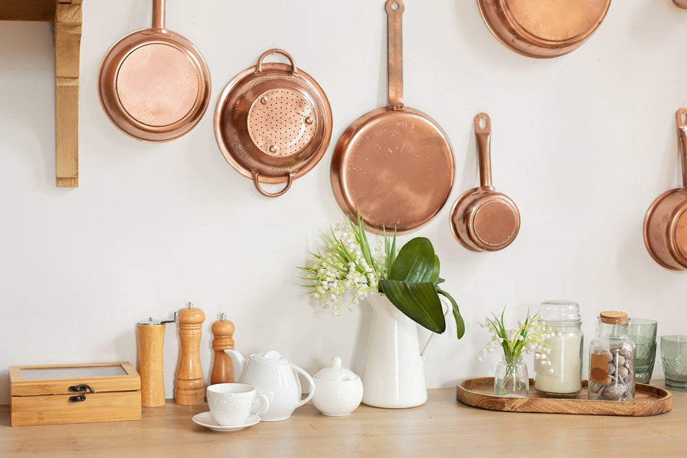 a kitchen displayed with copper cookware