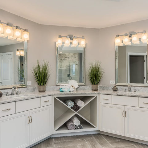 Enough lightng decors and mirror in a large restroom with vanity