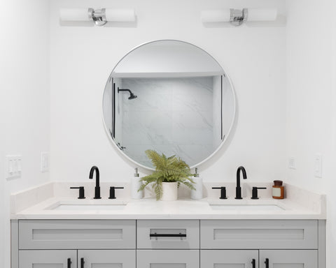 A double sink perfect bathroom vanity with rouded mirror