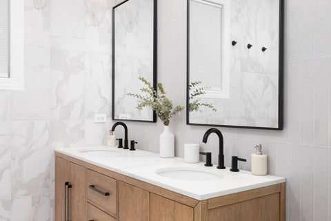 A wood perfect bathroom vanity with two mirror with black frame