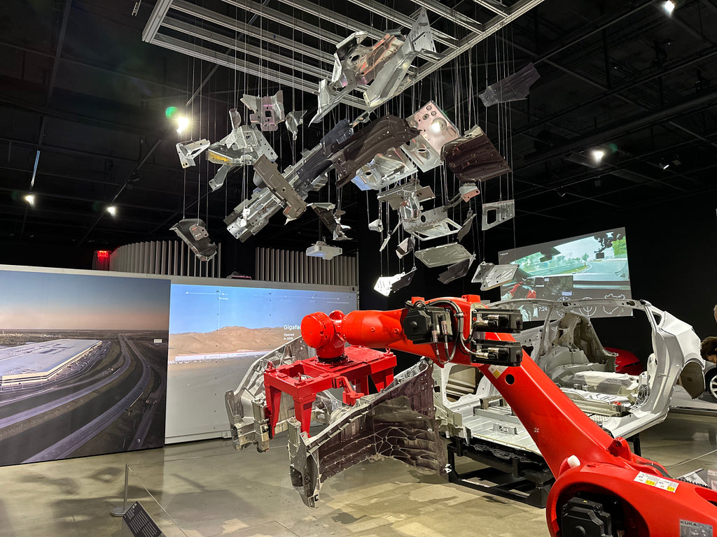 Tesla Model Y body frame with rear and front underbody Giga Castings at the Petersen Museum.