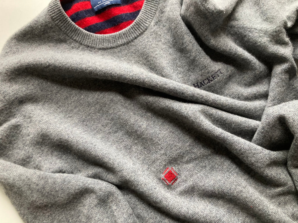 small red darned patch visible mending on grey jumper by slow stitch club