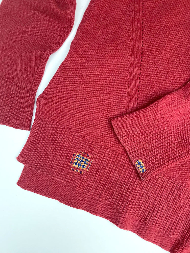 houndstooth darn weave on a red cashmere jumper visible mending