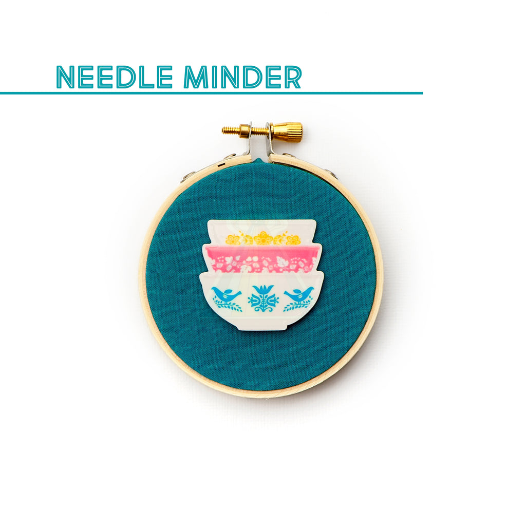 How to use a needle minder for cross stitch and embroidery - Stitched Modern