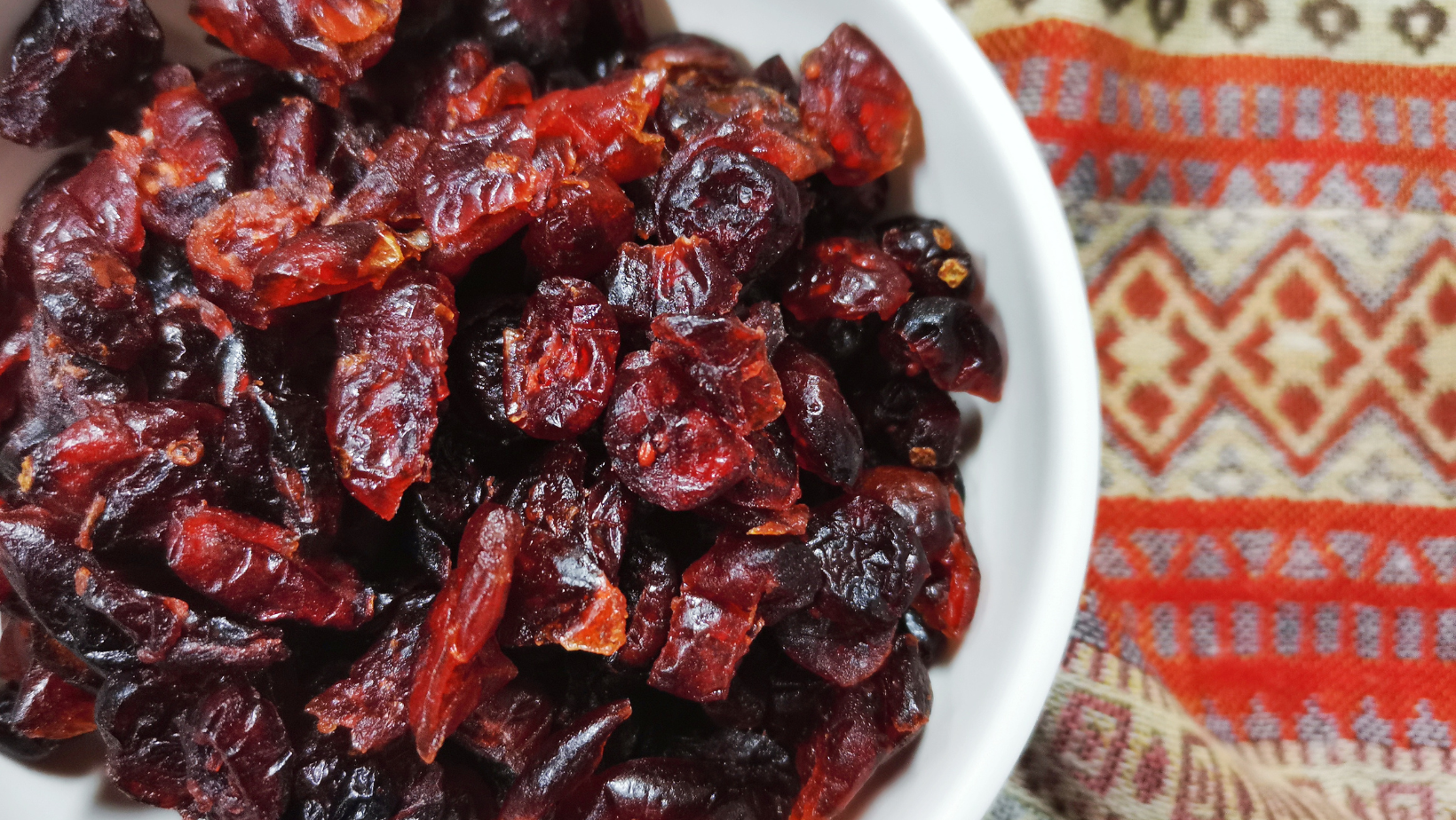 A vibrant, colorful bowl of dried cranberries symbolizing health and vitality.