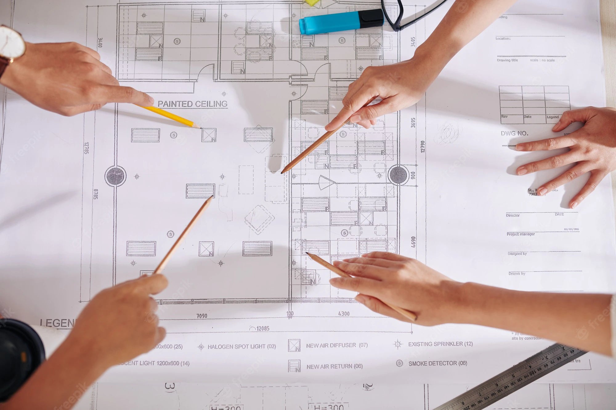 hands-architects-designers-pointing-blueprint-table-when-discussing-future-interior-design-project_274689-20802