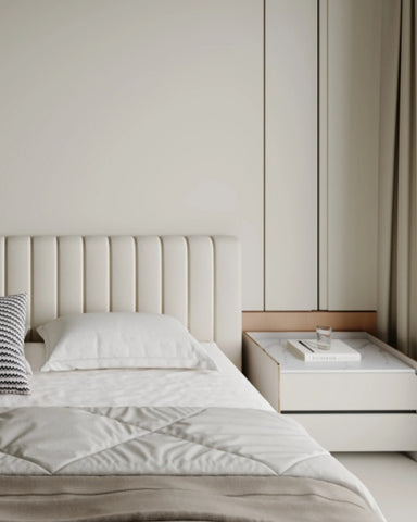 The headboard of the minimalist beige upholstered bed display