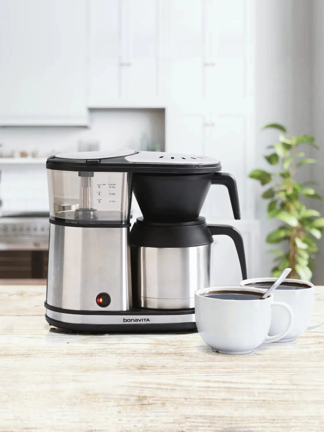 https://cdn.shopify.com/s/files/1/0633/1947/4396/products/bonavita_thermal-carafe-coffee-brewer_5-cup_kitchen-table_1800x1800_84f7ab85-2c39-439a-85c1-a06ea0d13f1b.webp?v=1676419981