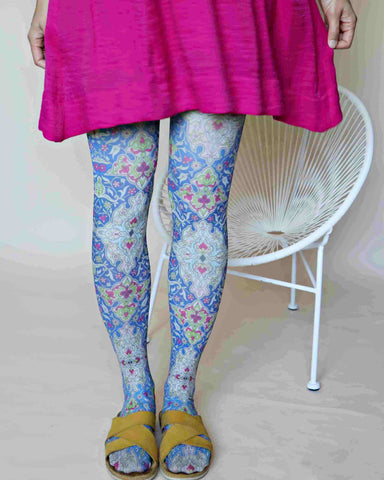 Pairing pink dress with patterned tights.