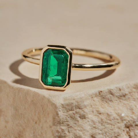 yellow gold bezel set green emerald