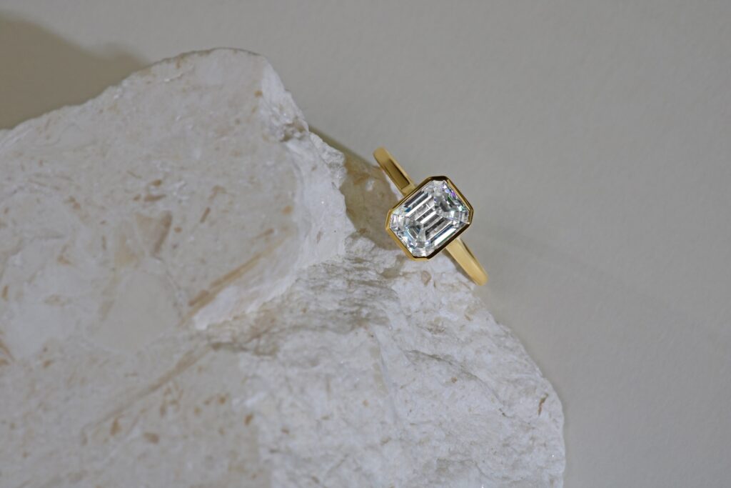 dainty engagement ring on a stone with a large carat diamond