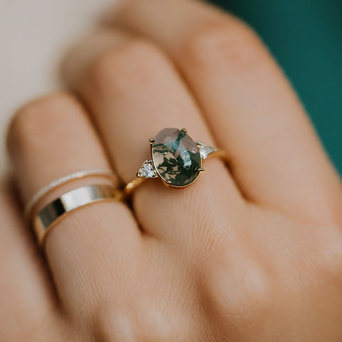 Three stone oval moss agate engagement ring in yellow gold